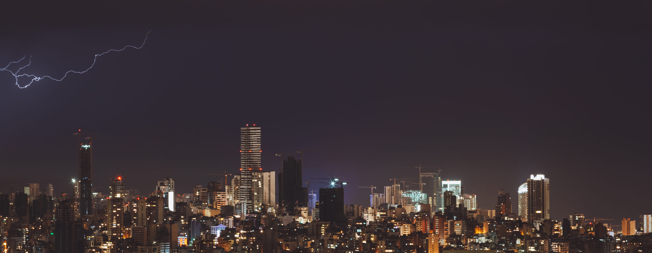 Panoramic photo of a Beirut City at Night. Thunderstorm and Lightning over Beautiful Cityscape. Nighttime View. Lebanon.
